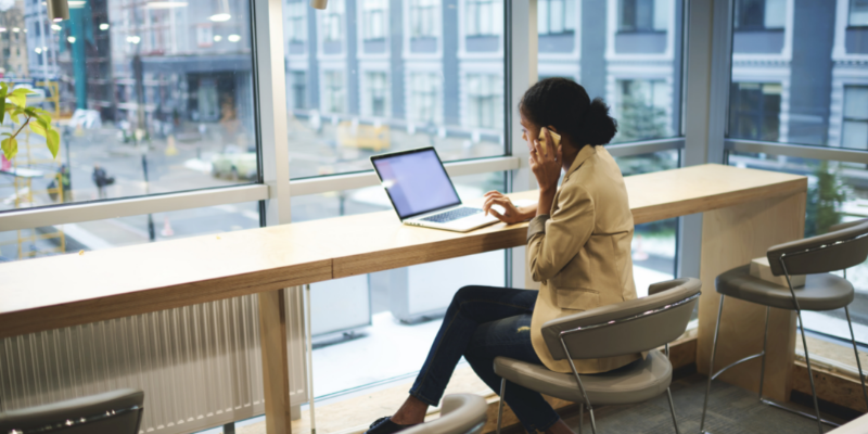 Business owner reading emails on her laptop.