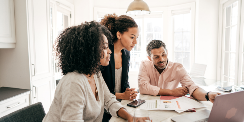 Family sitting around a table creating a funding strategy for their business.