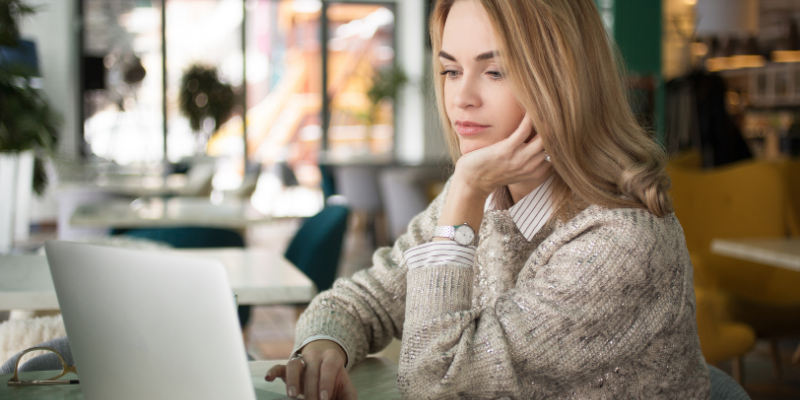 Woman reading on her laptop. 