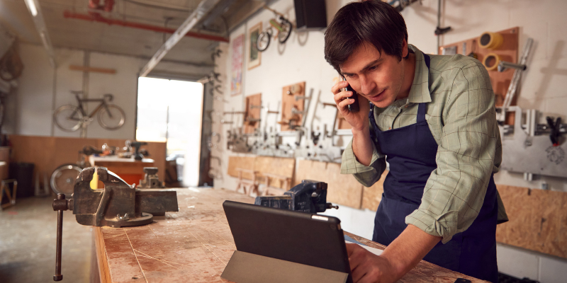 Small business owner speaking to a potential customer on the phone.