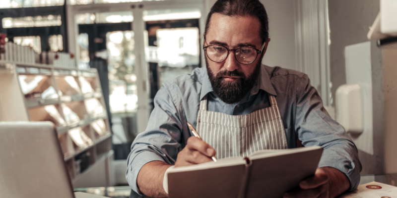 Pastry shop owner doing bookkeeping.