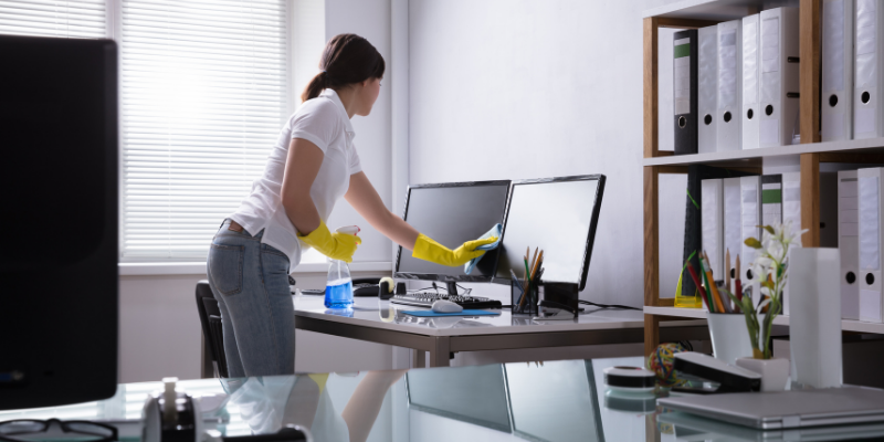 Woman cleaning an office. 