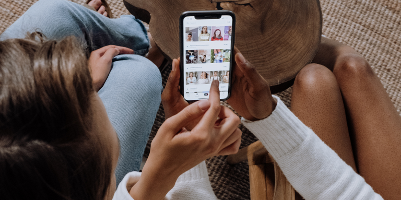 Two women looking at photos on social media. 