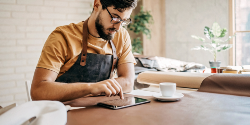 upholstery business owner entering information on a tablet.