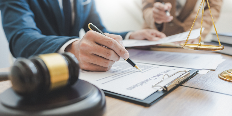 Person signing legal papers.