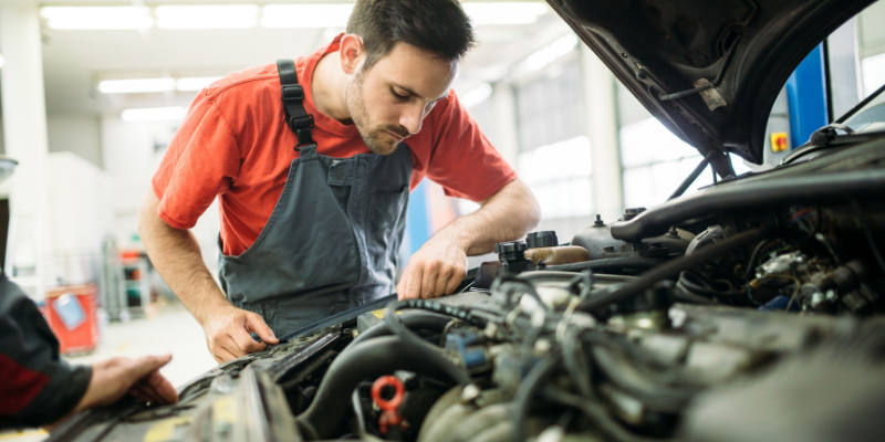 Mechanic working on a car. 