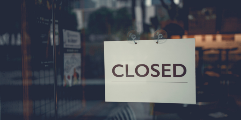 Storefront showing a closed sign on the door.