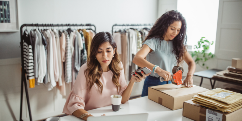 A business owner and an employee putting together orders.