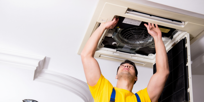HVAC contractor fixing a heater.