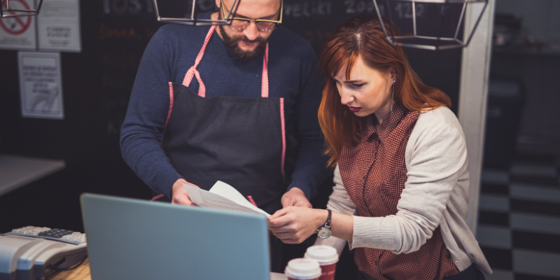 Two business owners looking at paperwork.