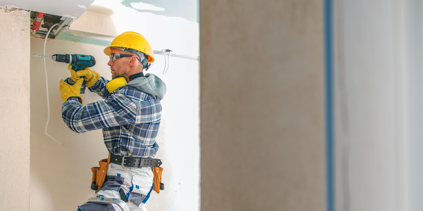 General contractor drilling into a wall. 