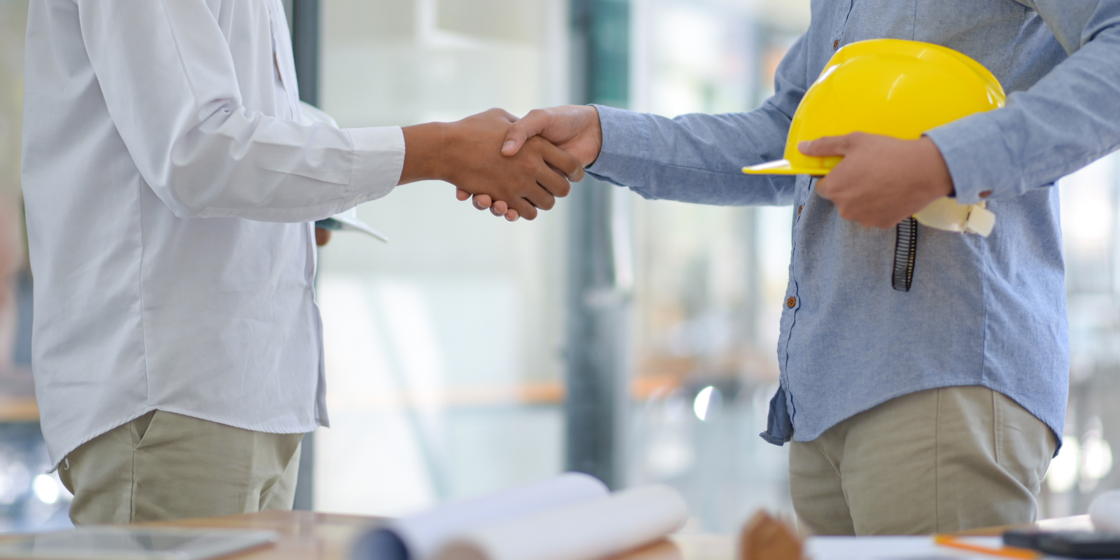 General contractor shaking hands and sealing a business deal.