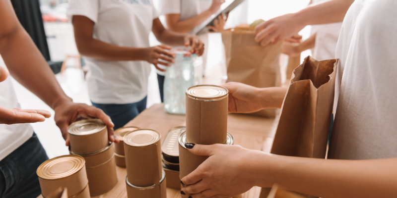 team members passing out food at a food drive.