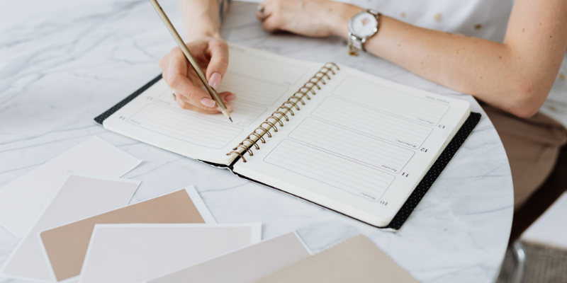 woman writing in a planner