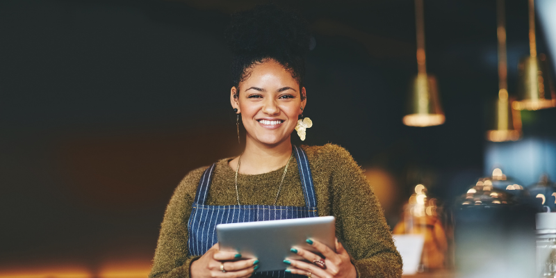 Woman business owner holding an iPad.