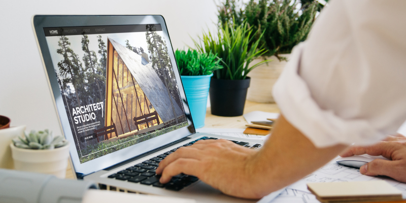 Business owner building his custom website on a laptop.