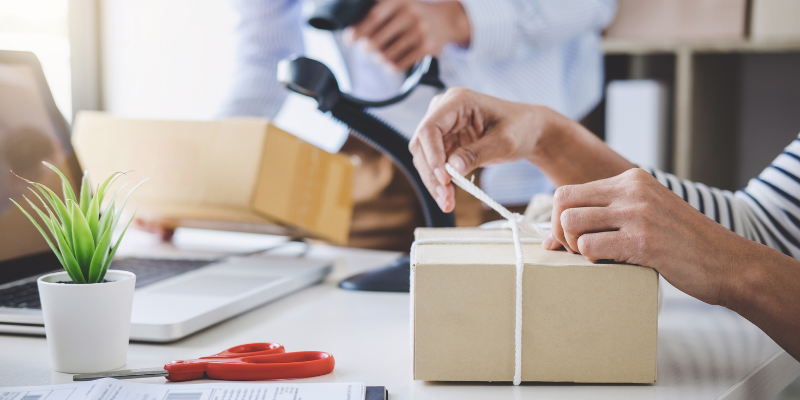 Business owner preparing a package for shipping.