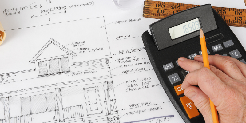 General contractor punching numbers into a calculator.