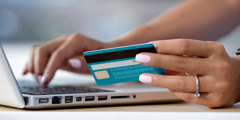 woman inputting credit card information into a computer