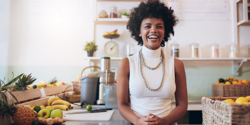 Black woman business owner standing in front of her counter. featured_image