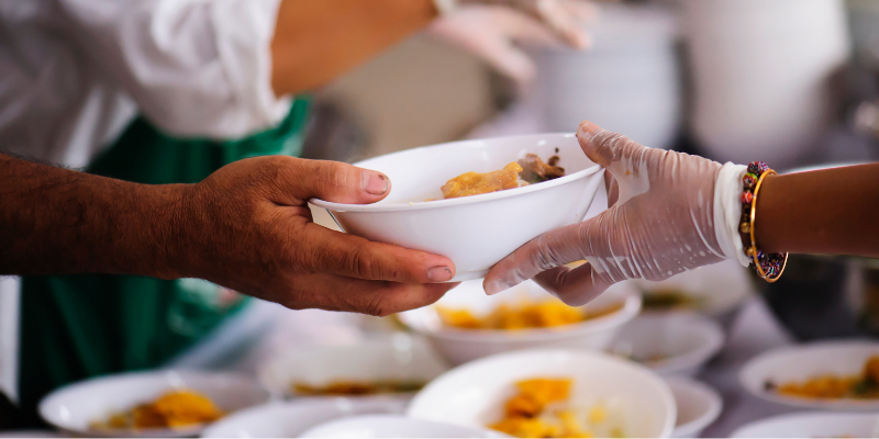 person handing out food. featured_image