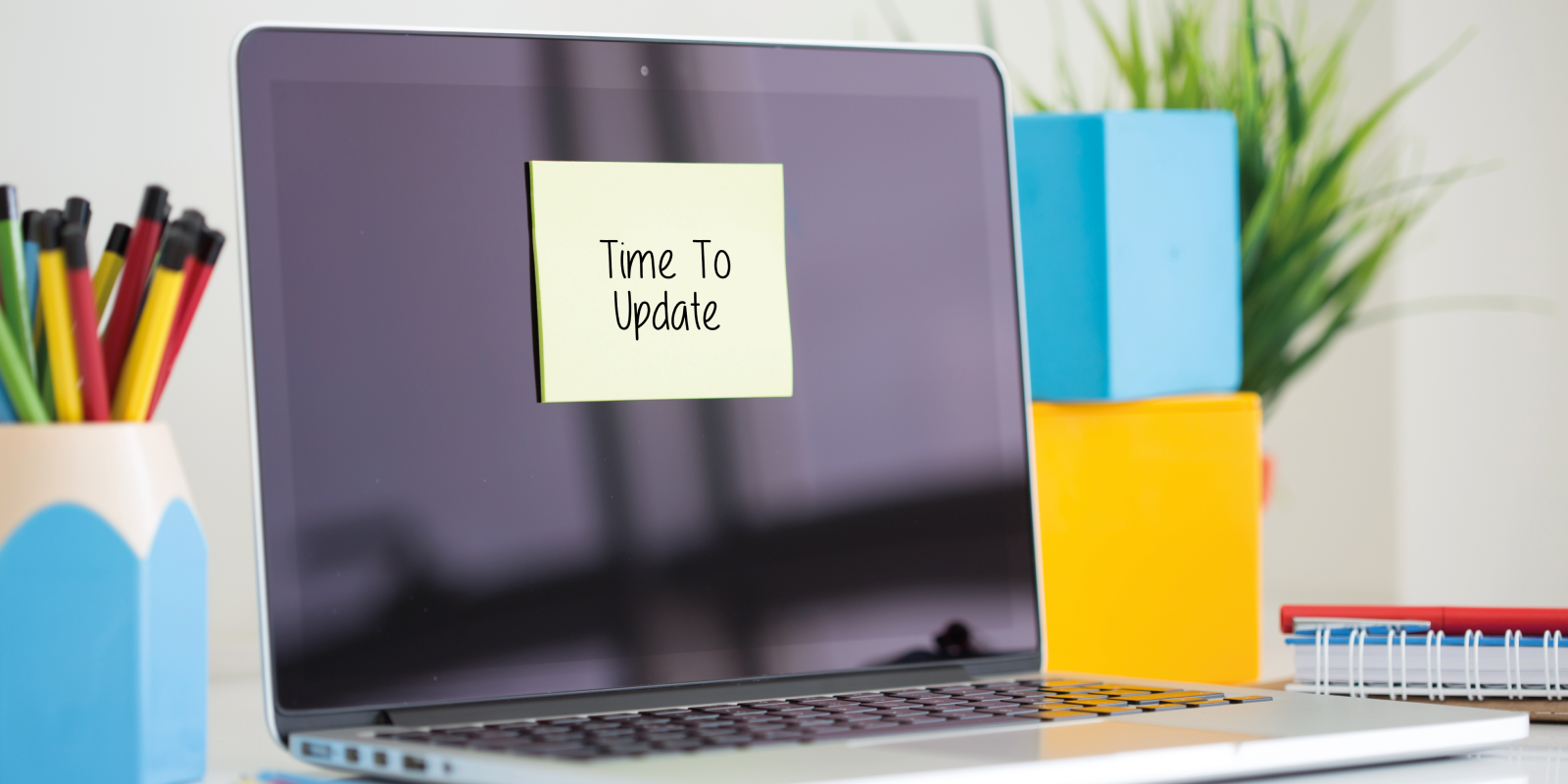 computer screen with a sticky note on it saying 