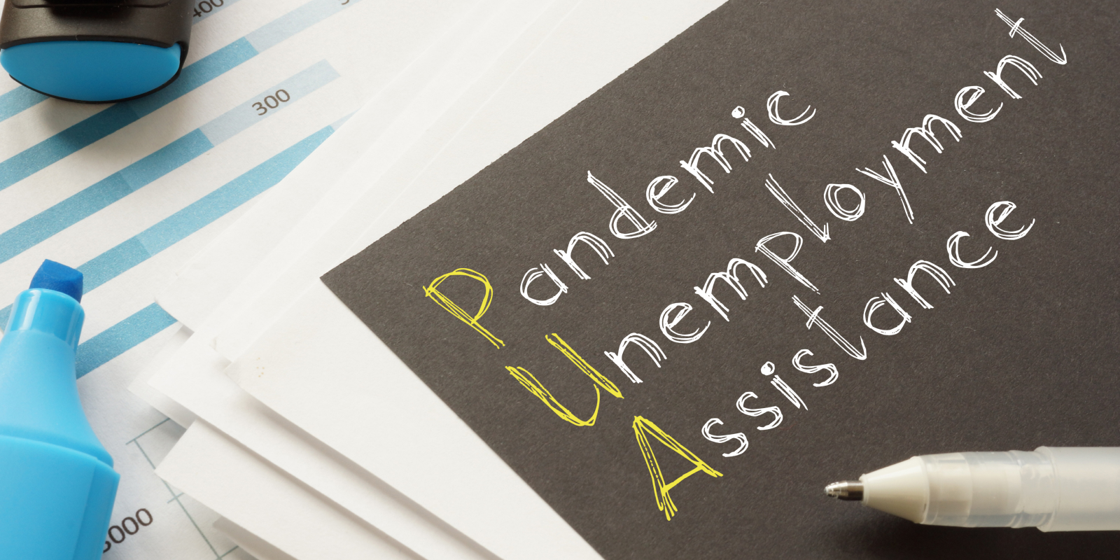 pandemic unemployment assistance written on a black piece of paper