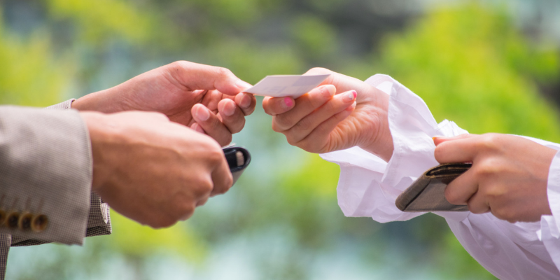 A man and a woman exchanging a business card